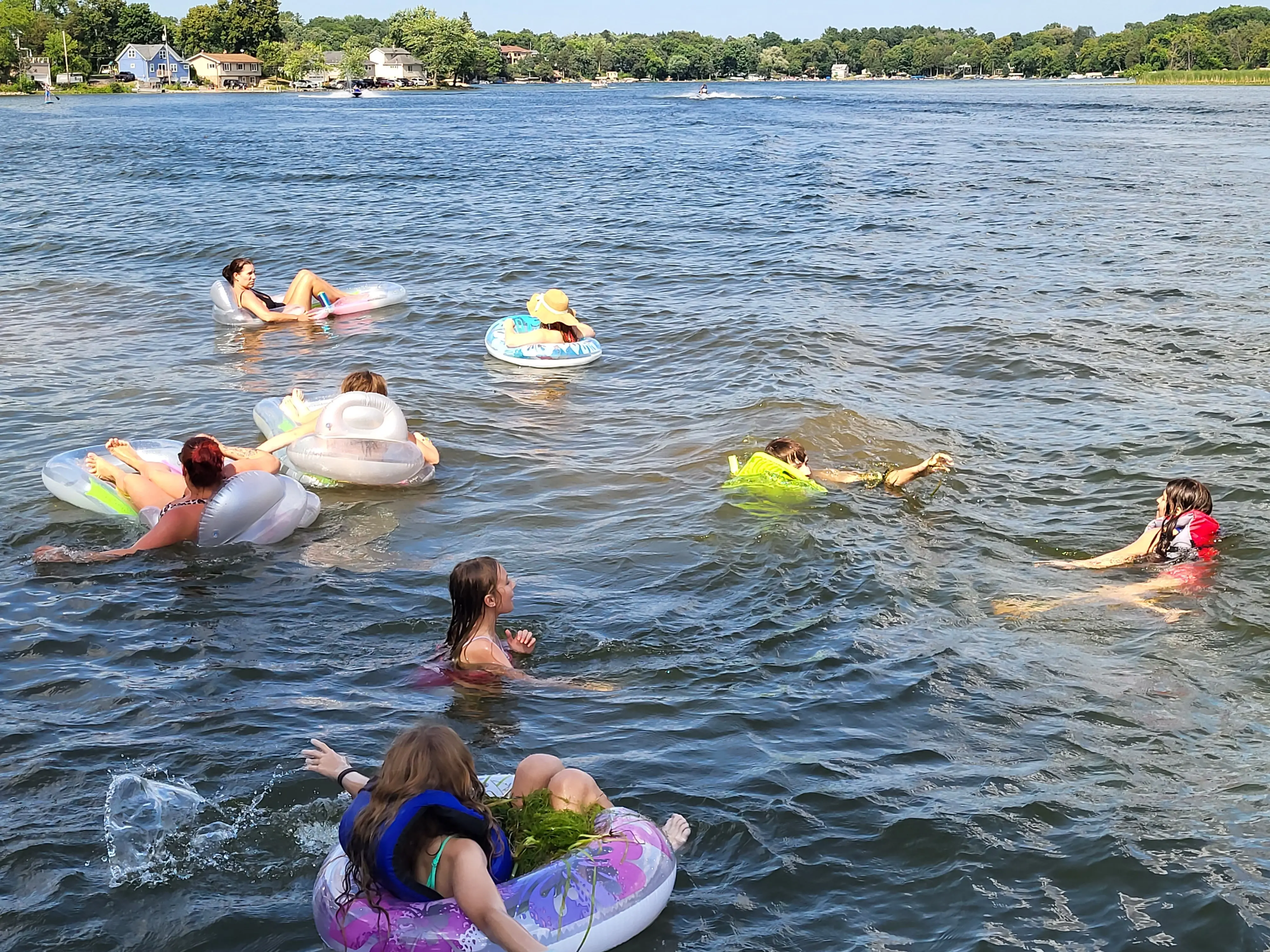 Families floating and swimming on the lake
