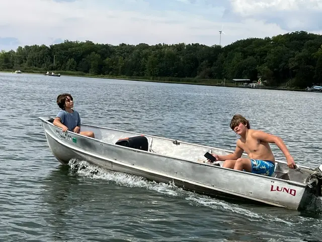 Two kids fishing from a boat